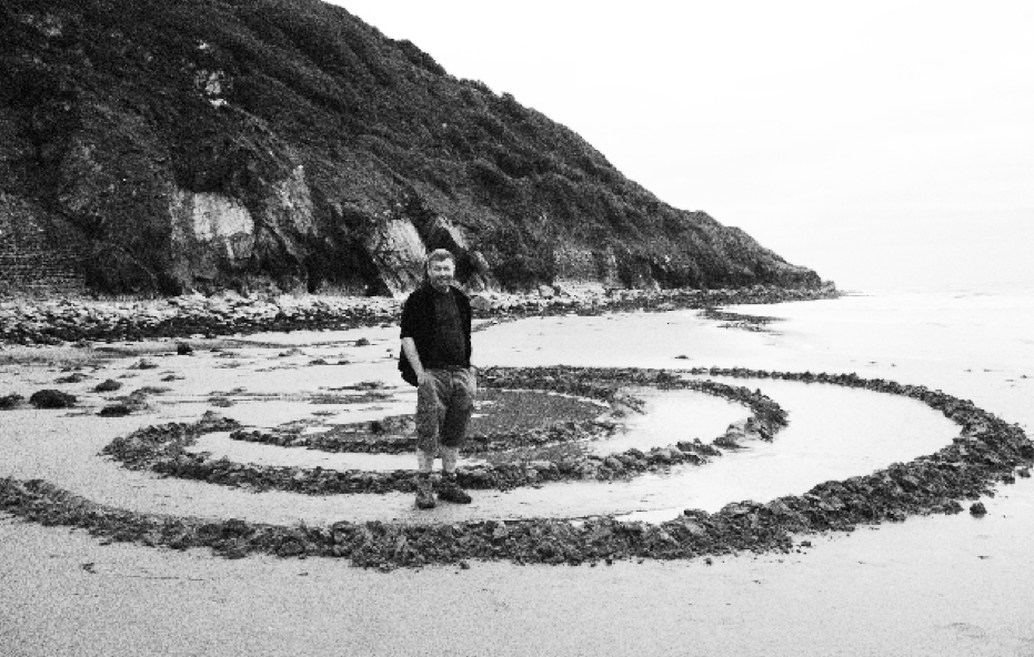 Danny Dorling building drip sandcastles in Wales spiral
